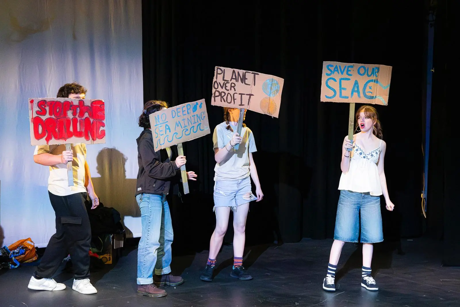 WhatsApp Image 2025-04-29 at 21.46.40 (2) protest scene with placards with the slogans save our sea, planet over profit, no deep sea mining and stop the drilling