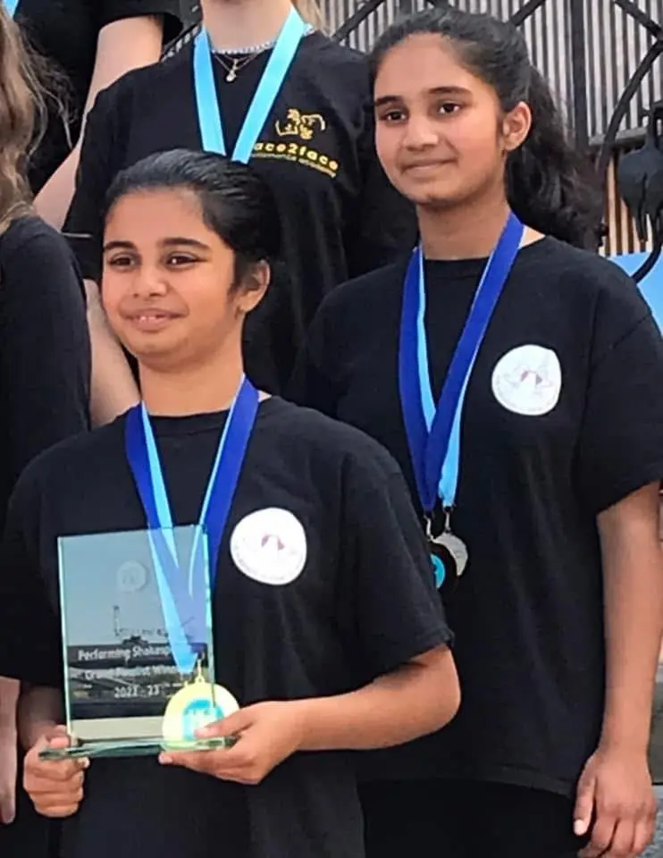 ESU 3 The girls wearing their winning medals and holding their certificates