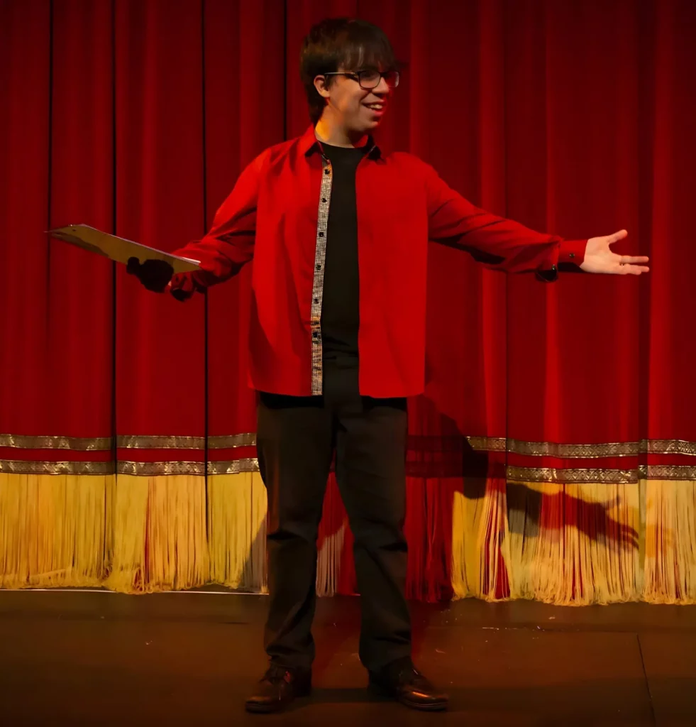 Sam Kavakli on stage as a compare for the Robinson Academy of Drama